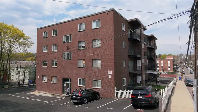 a view of a street that has couple of cars parked on the road