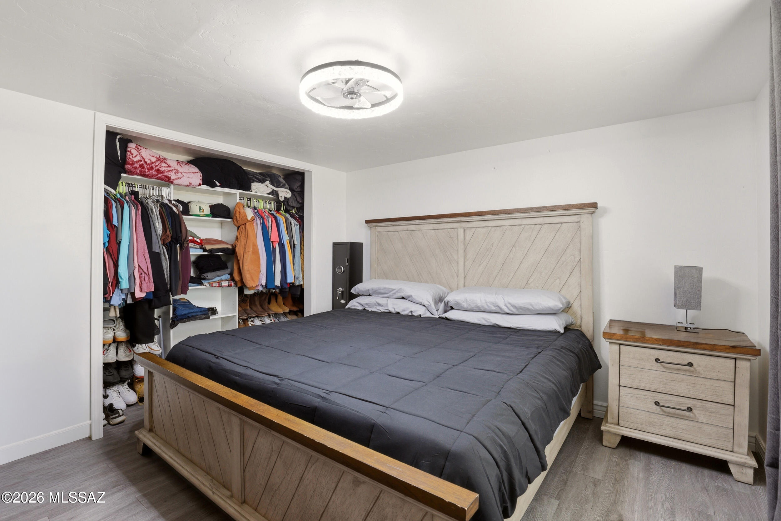 8620 South Sandario Road Tucson, AZ 85736 - Photo 14 of 26 a bedroom with a bed and a walk in closet