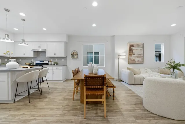 a living room with furniture and floor to ceiling window