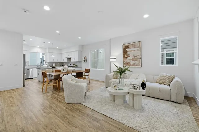 a kitchen with granite countertop white cabinets and stainless steel appliances