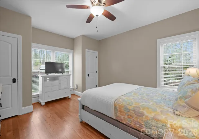 a bathroom with a tub a window and shower