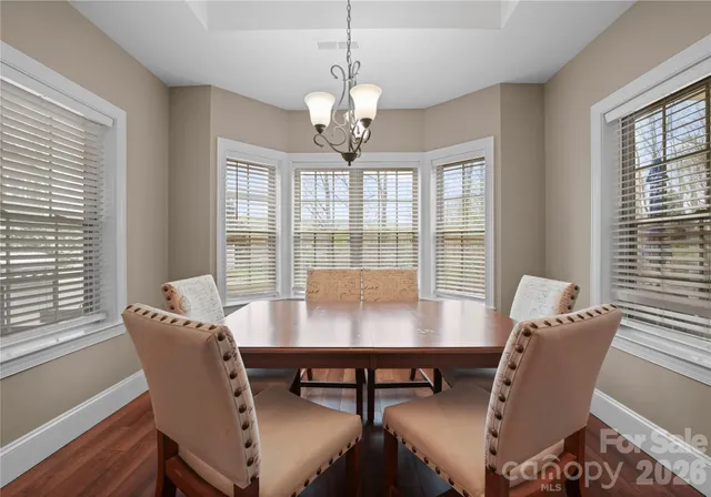 a backyard of a house with garden table and chairs