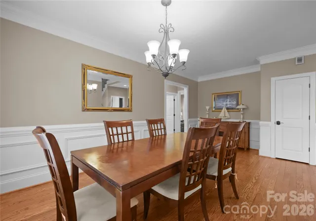 a kitchen with granite countertop white cabinets and stainless steel appliances
