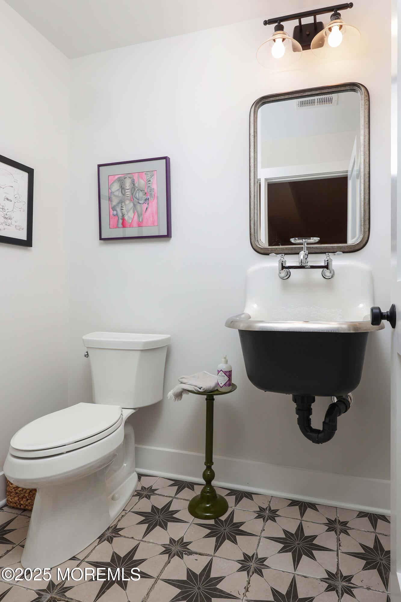 41 Forrest Avenue Rumson, NJ 07760 - Photo 19 of 32 a bathroom with a toilet a sink and mirror
