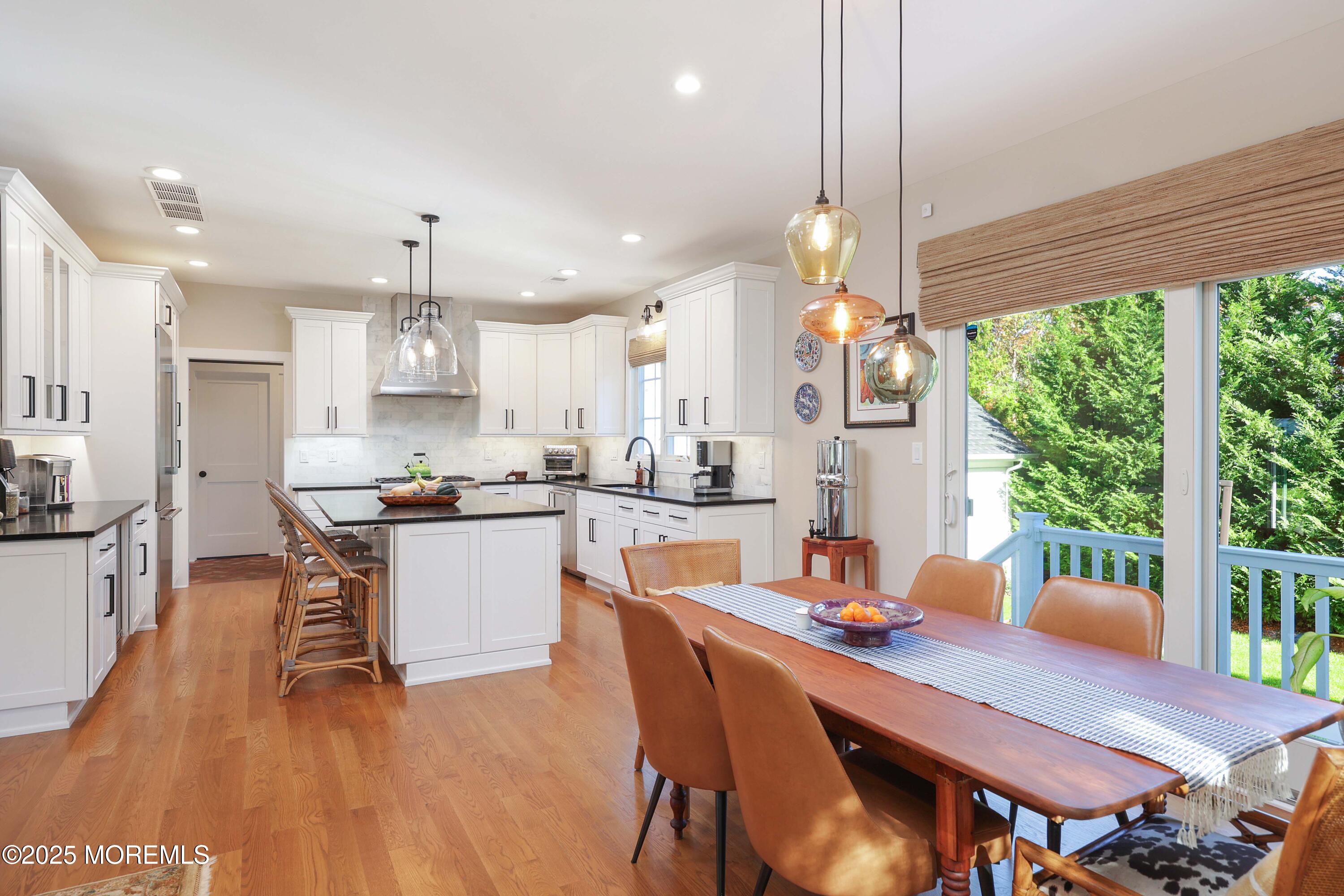 41 Forrest Avenue Rumson, NJ 07760 - Photo 6 of 32 a dining room with stainless steel appliances kitchen island granite countertop a table chairs and a living room view