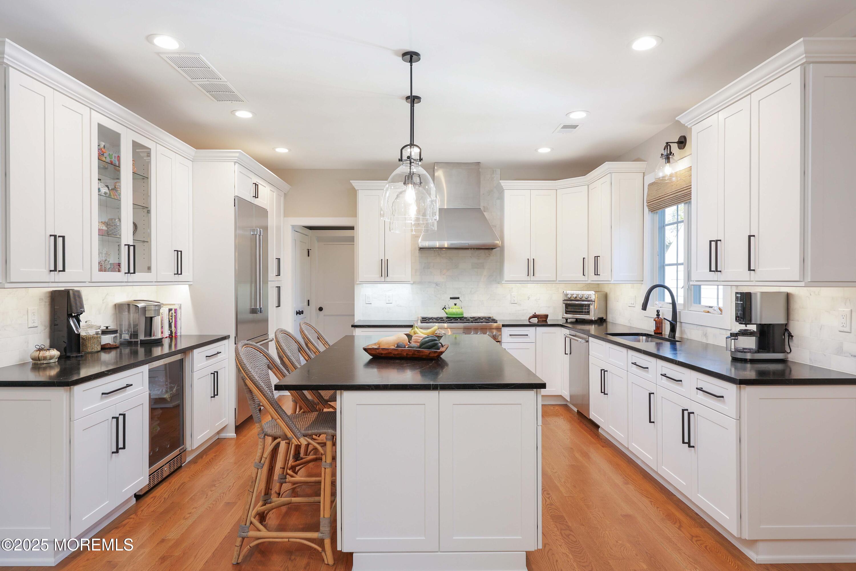 41 Forrest Avenue Rumson, NJ 07760 - Photo 7 of 32 a kitchen with stainless steel appliances granite countertop a sink stove and refrigerator