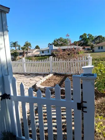 a view of a house with wooden fence