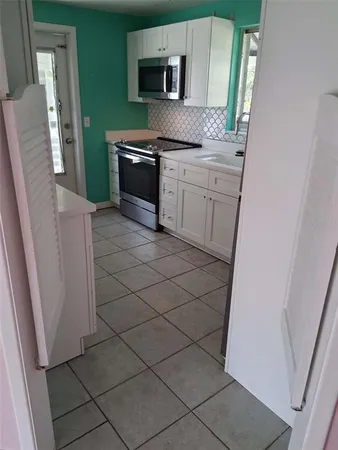 a kitchen with a sink and a stove top oven