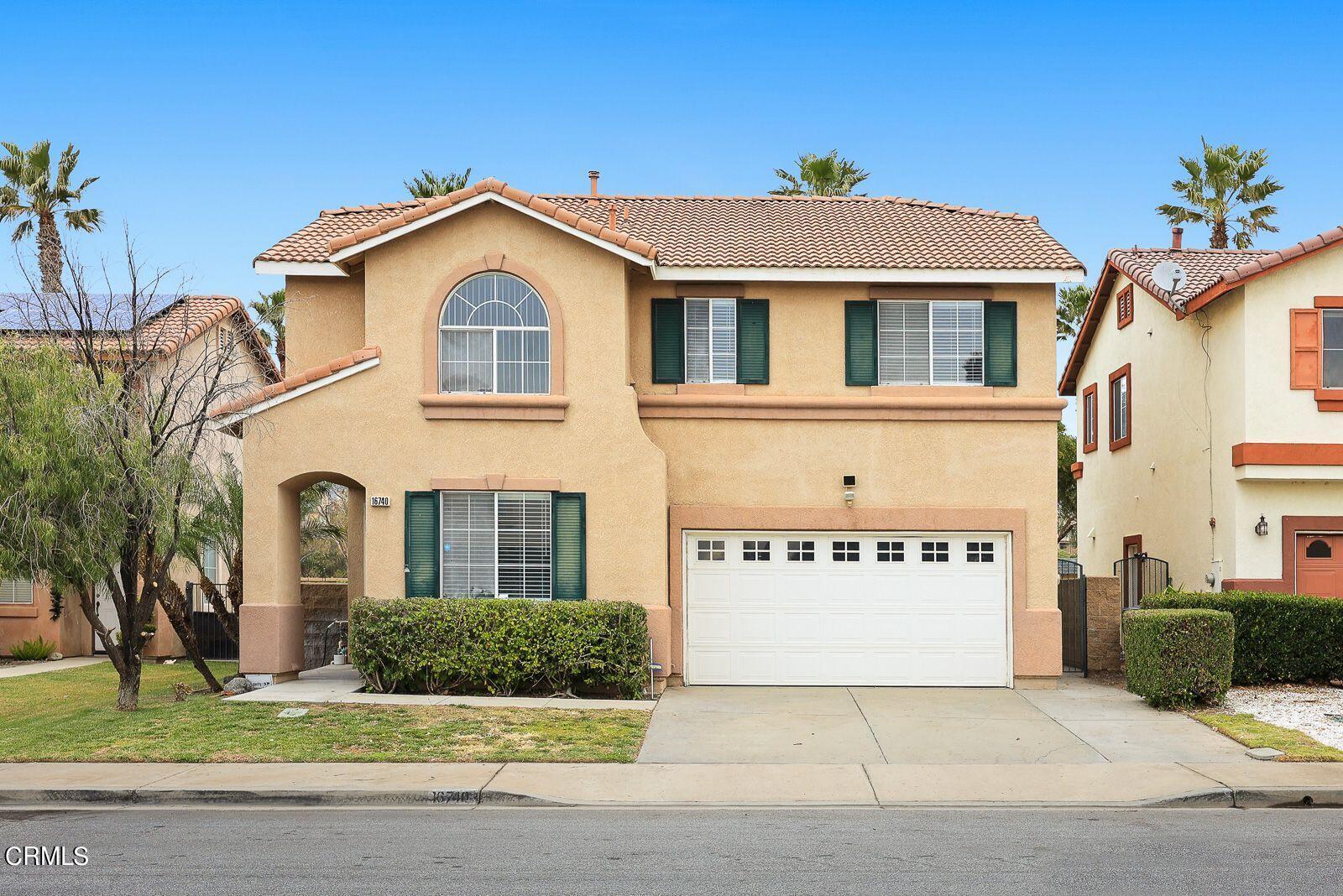 16740 Inverrary Way Fontana, CA 92336 - Photo 1 of 29 a view of a white house with a large windows