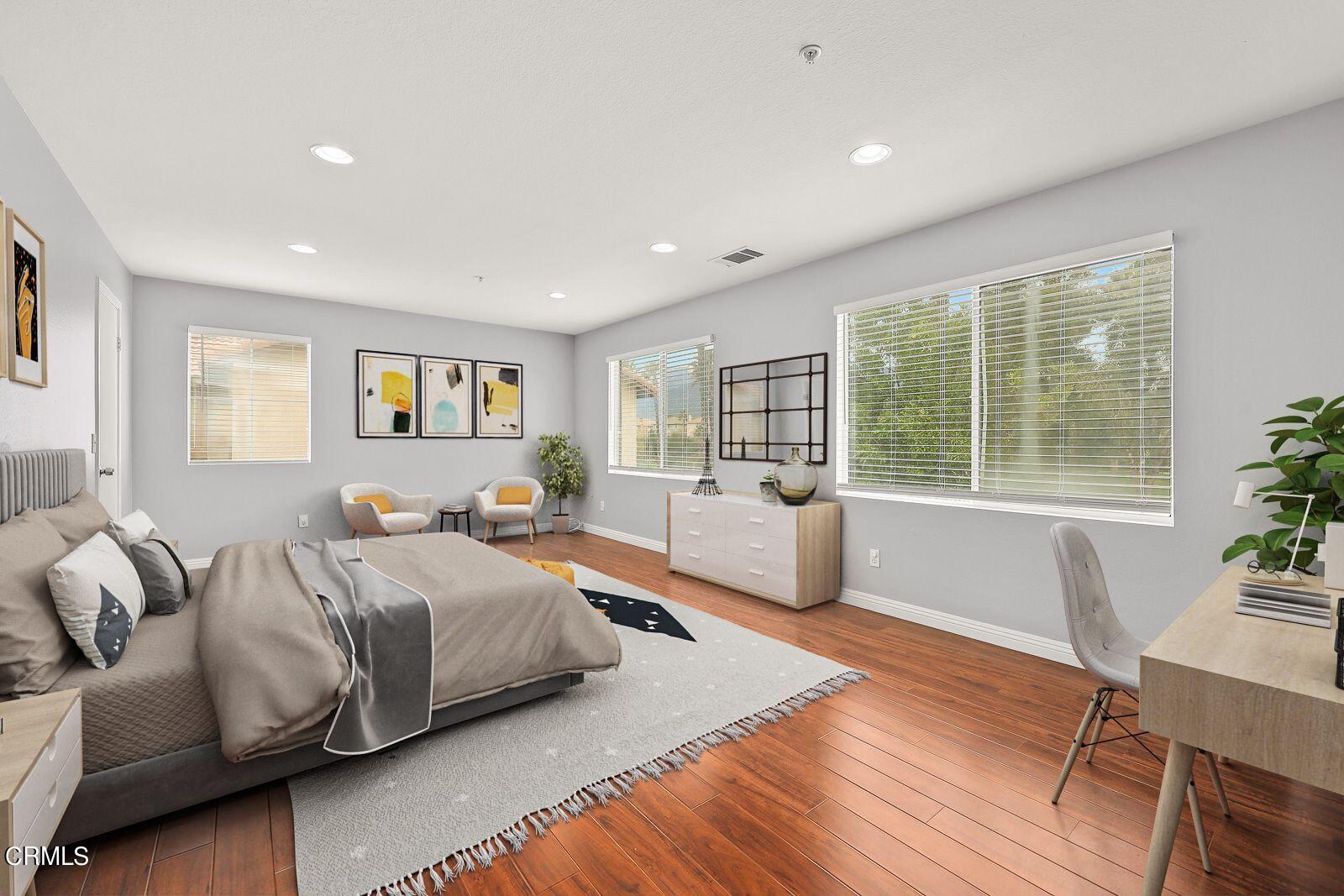 16740 Inverrary Way Fontana, CA 92336 - Photo 14 of 29 a spacious bedroom with a large bed and a large window