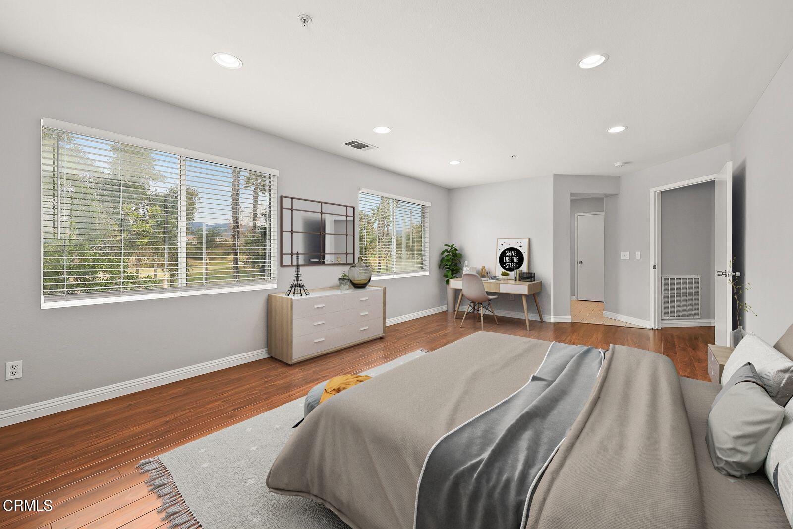 16740 Inverrary Way Fontana, CA 92336 - Photo 15 of 29 a bedroom with a large bed and a large window