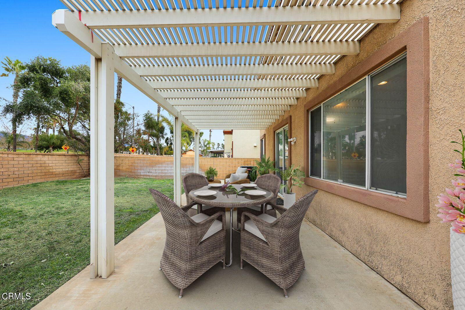 16740 Inverrary Way Fontana, CA 92336 - Photo 25 of 29 a backyard of a house with table and chairs