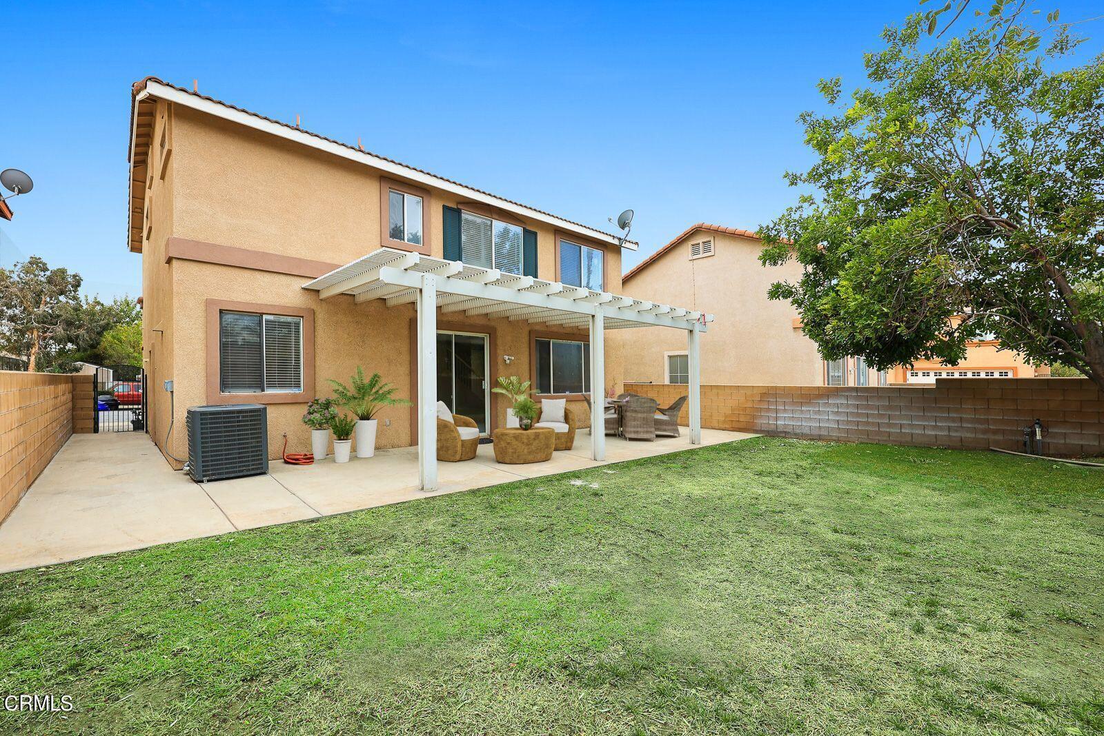 16740 Inverrary Way Fontana, CA 92336 - Photo 26 of 29 a view of a house with backyard porch and sitting area