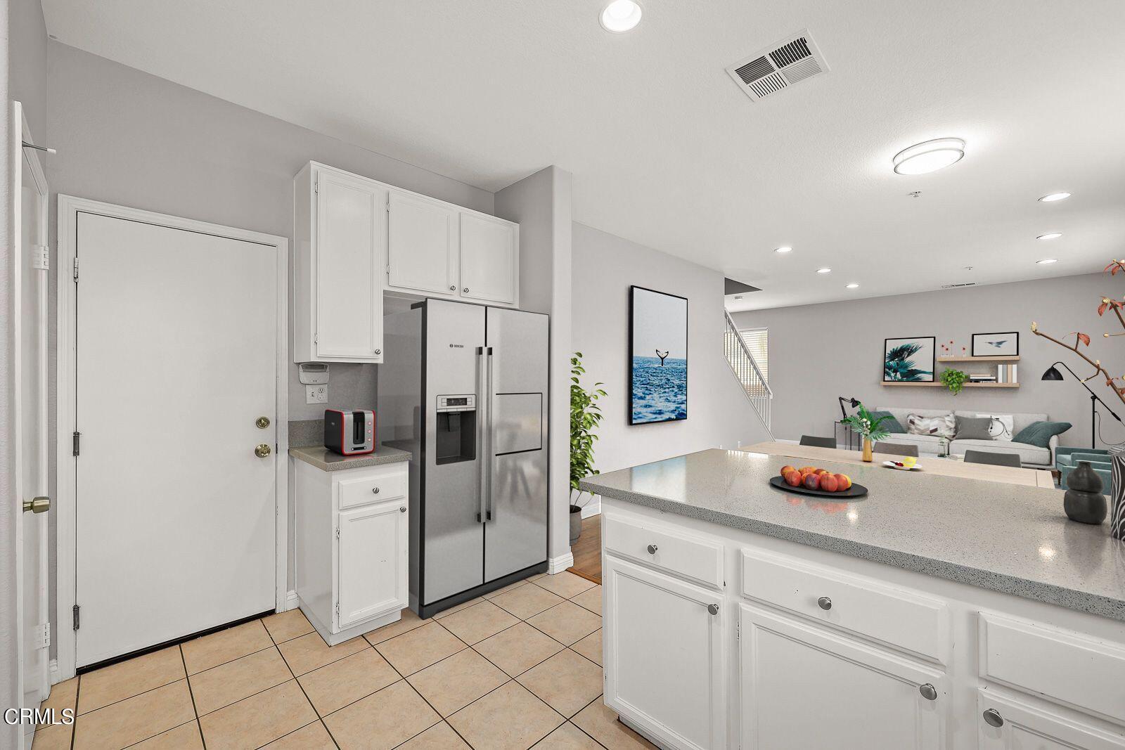 16740 Inverrary Way Fontana, CA 92336 - Photo 10 of 29 a kitchen with stainless steel appliances a refrigerator and a sink