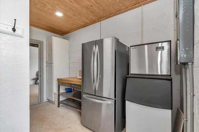 a metallic refrigerator freezer sitting in a kitchen