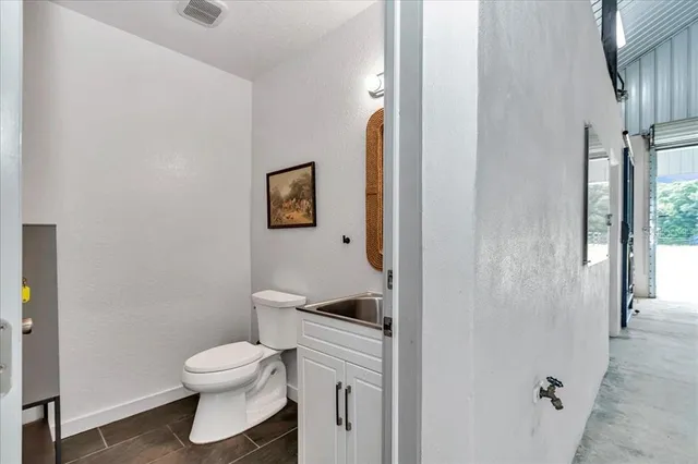 a white toilet sitting next to a bathroom sink
