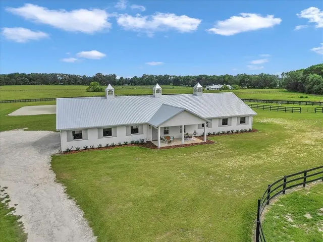 an aerial view of a house with a garden and a yard