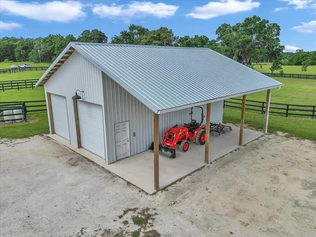 a view of a barn in a yard