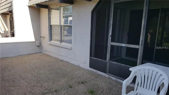 a view of a swimming pool with a table and chairs