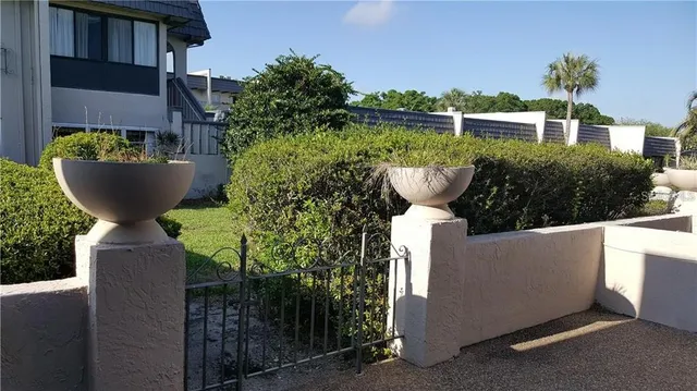 a view of a swimming pool with a patio and plants