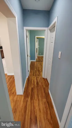 a view of hallway with wooden floor