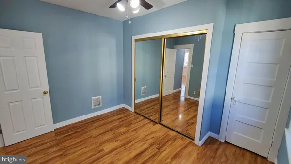 a view of room with window and wooden floor