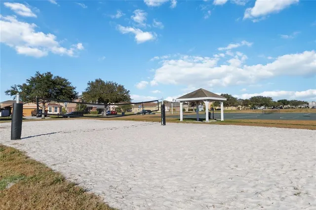 a front view of a house with a yard and fountain
