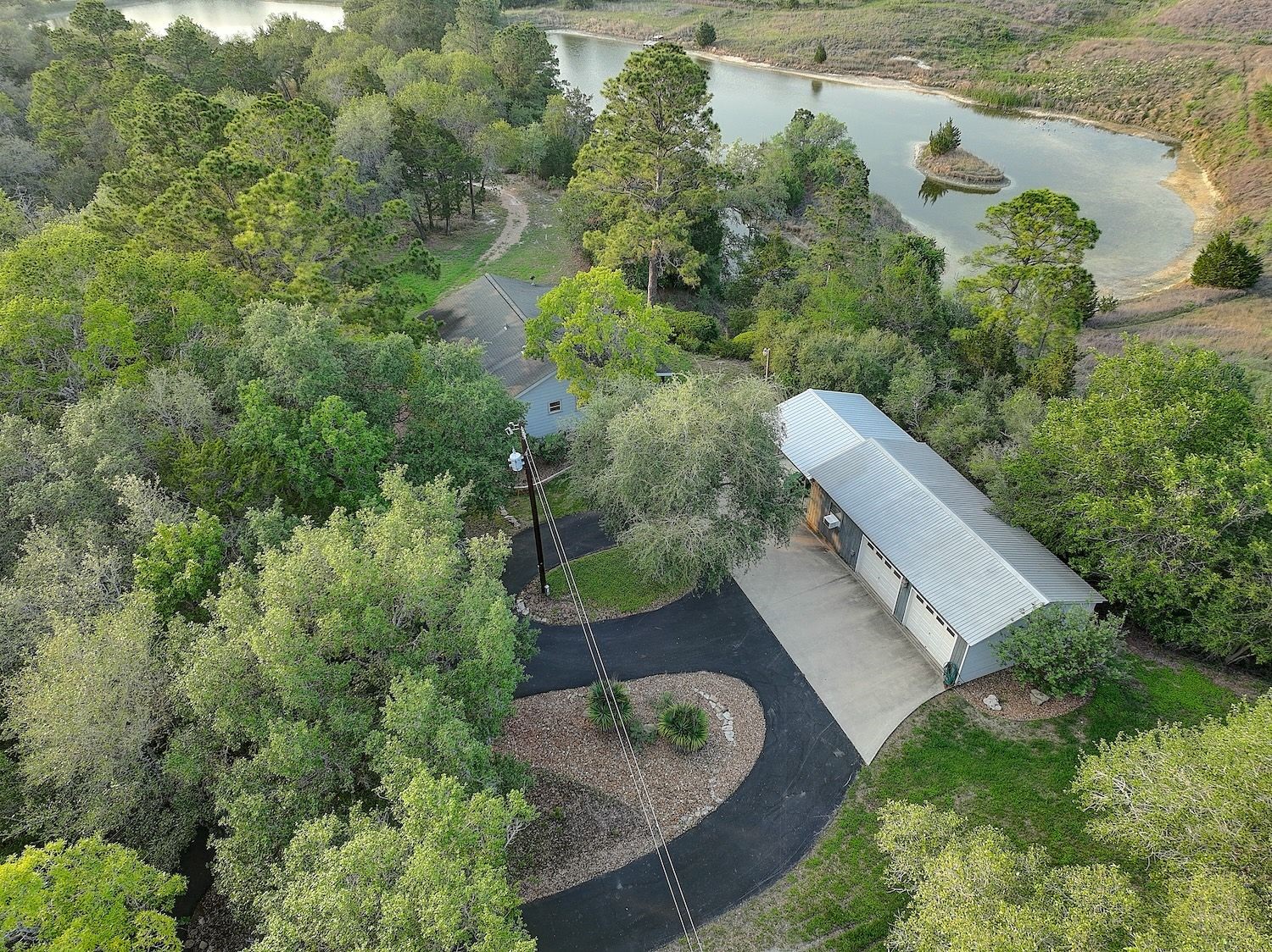 Entryway driveway with a circle drive with a beautiful wooded setting