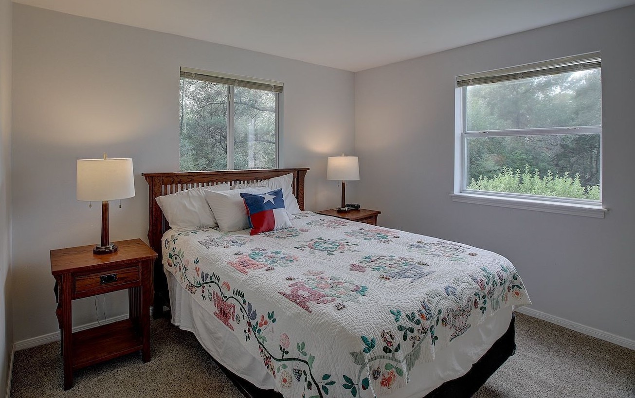 4540 Creamer Creek Road La Grange, TX 78945 - Photo 14 of 32 The bedroom with large windows allowing nature to enter with loads of light.