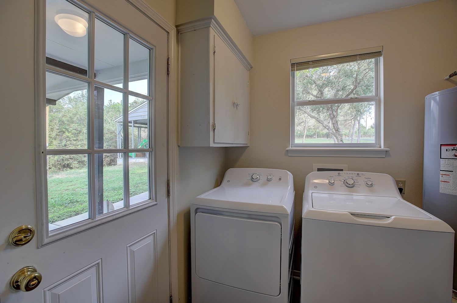 4540 Creamer Creek Road La Grange, TX 78945 - Photo 17 of 32 Utility room area with washer/dryer/water heater and lots of storage.