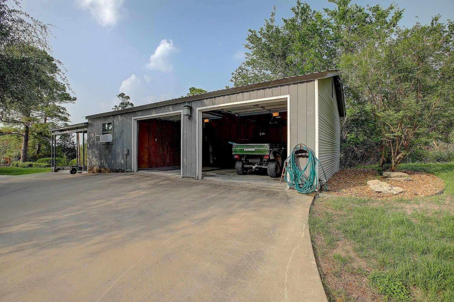 4540 Creamer Creek Road La Grange, TX 78945 - Photo 22 of 32 Garage space showing doors open for easy access upin arrival and storage for the ATV/RTV.
