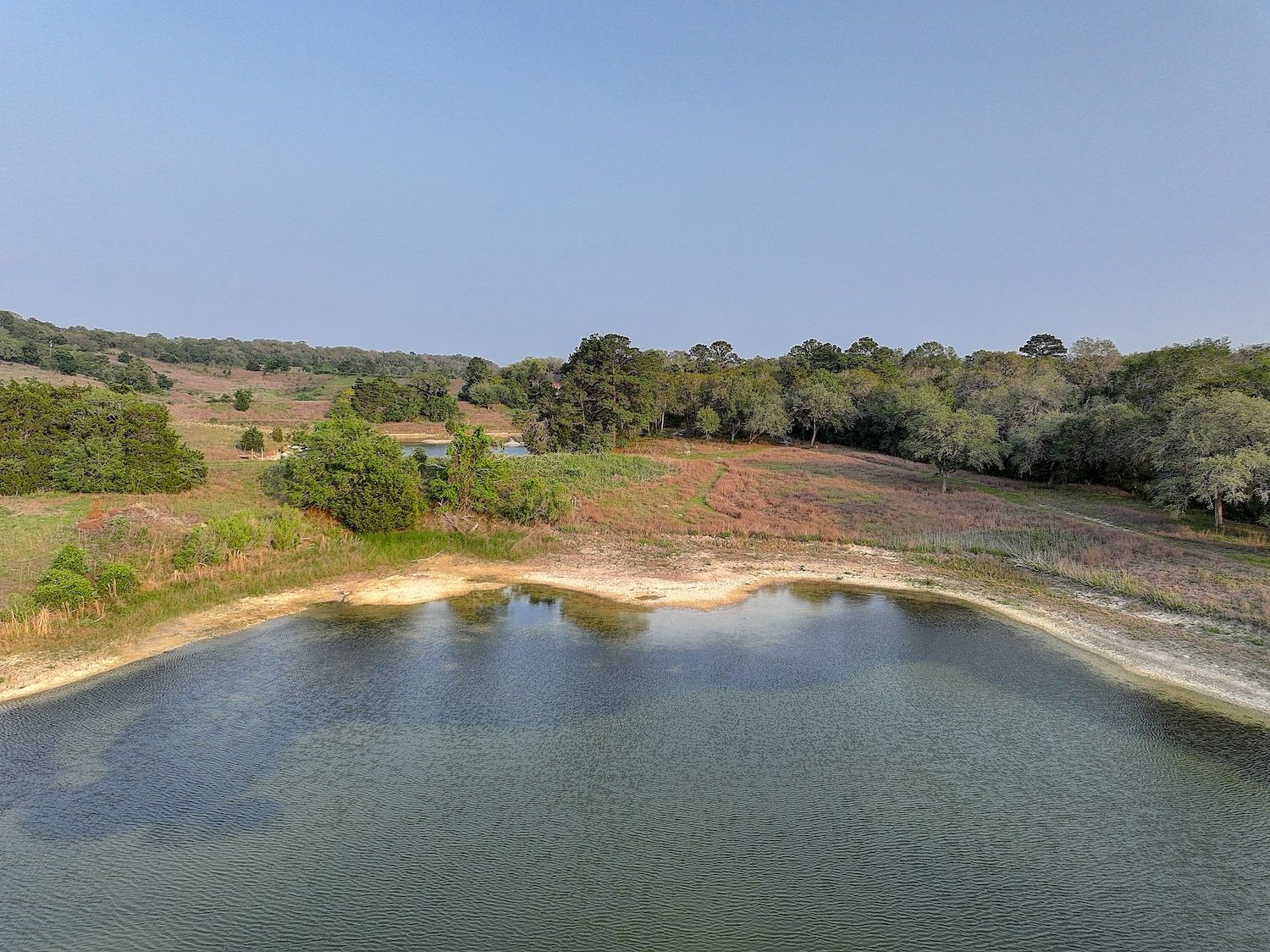4540 Creamer Creek Road La Grange, TX 78945 - Photo 26 of 32 Pond 2 that is stocked and always has water during droughts. Understanding that there are springs that enhance the water level.