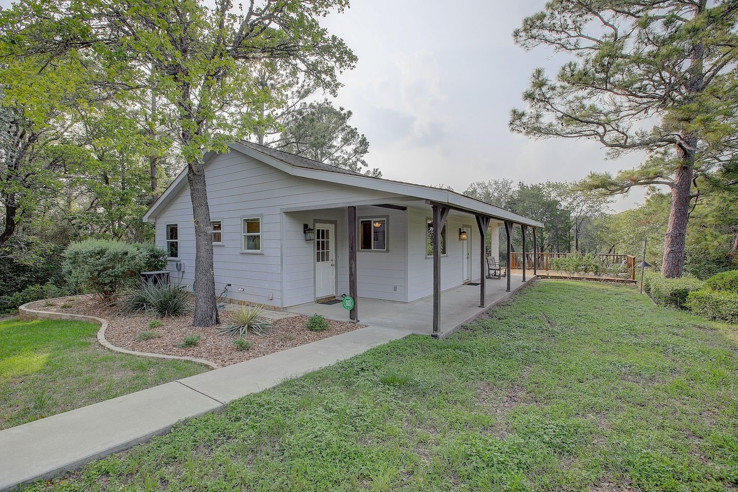4540 Creamer Creek Road La Grange, TX 78945 - Photo 6 of 32 Side view showing landscaping along with the accompanying wooden deck for outdoor relaxation