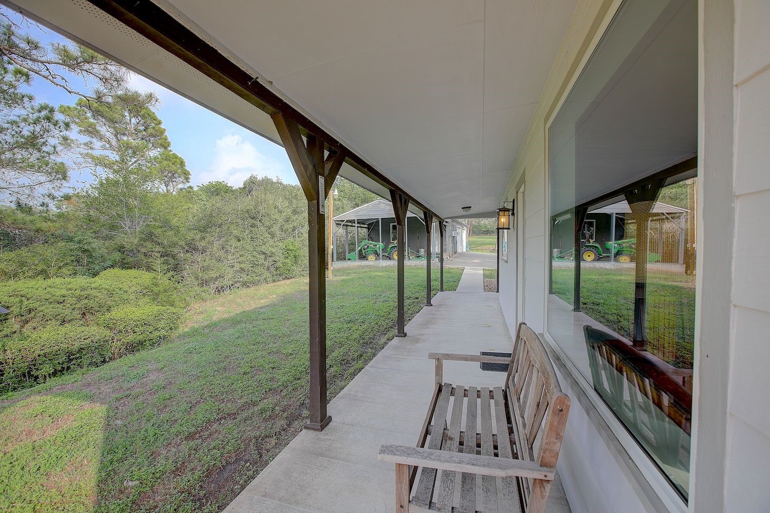 4540 Creamer Creek Road La Grange, TX 78945 - Photo 7 of 32 Closeup of the front porch with huge picture windows that bring the outdoors in.