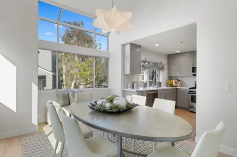 a kitchen with stainless steel appliances kitchen island granite countertop a sink a microwave a stove and chairs