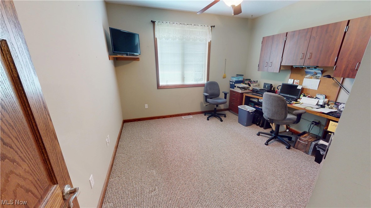 10323 Smith Road Litchfield, OH 44253 - Photo 25 of 50 Home office featuring light colored carpet, ceiling fan, and baseboards