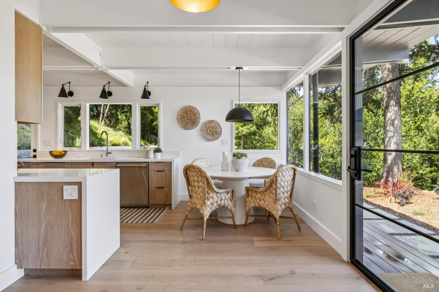 485 Scenic Road Fairfax, CA 94930 - Photo 27 of 75 a dining room with wooden floor a glass table and chairs