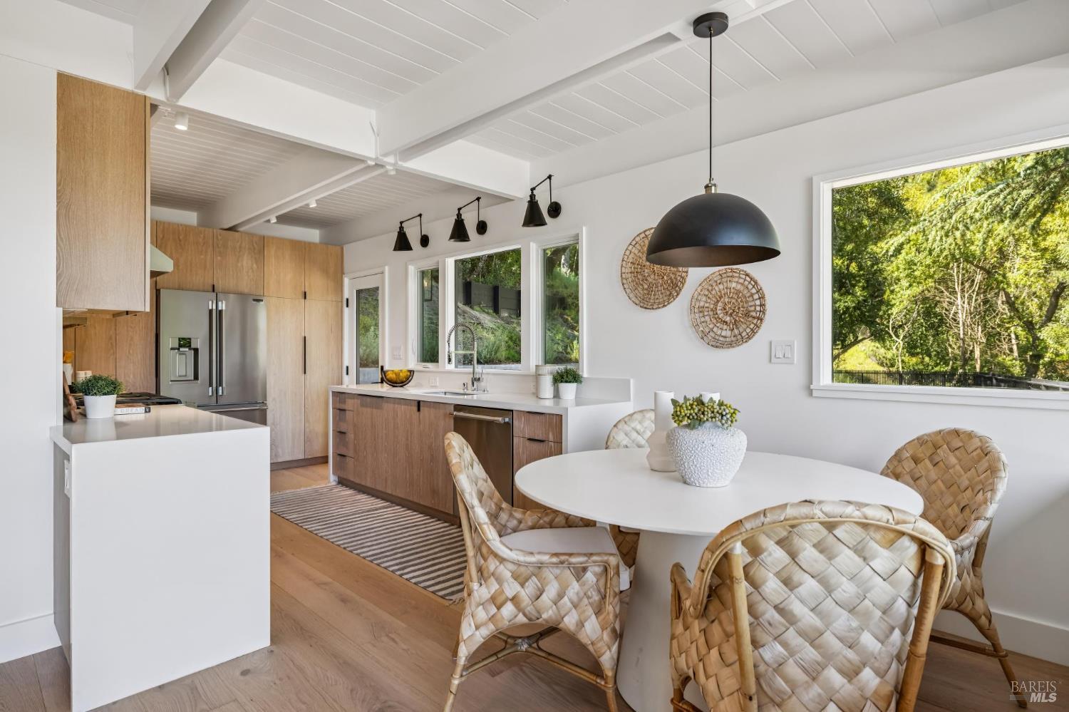 485 Scenic Road Fairfax, CA 94930 - Photo 29 of 75 a dining room with furniture a window and wooden floor