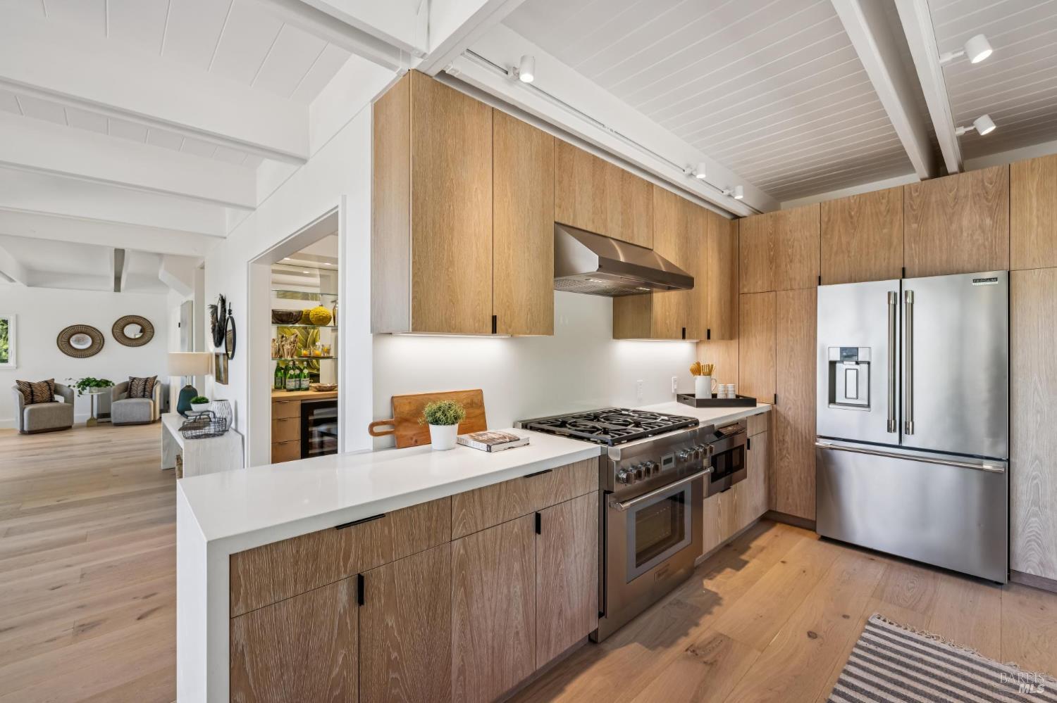 485 Scenic Road Fairfax, CA 94930 - Photo 31 of 75 a kitchen with stainless steel appliances granite countertop a stove a refrigerator a sink dishwasher and white cabinets with wooden floor