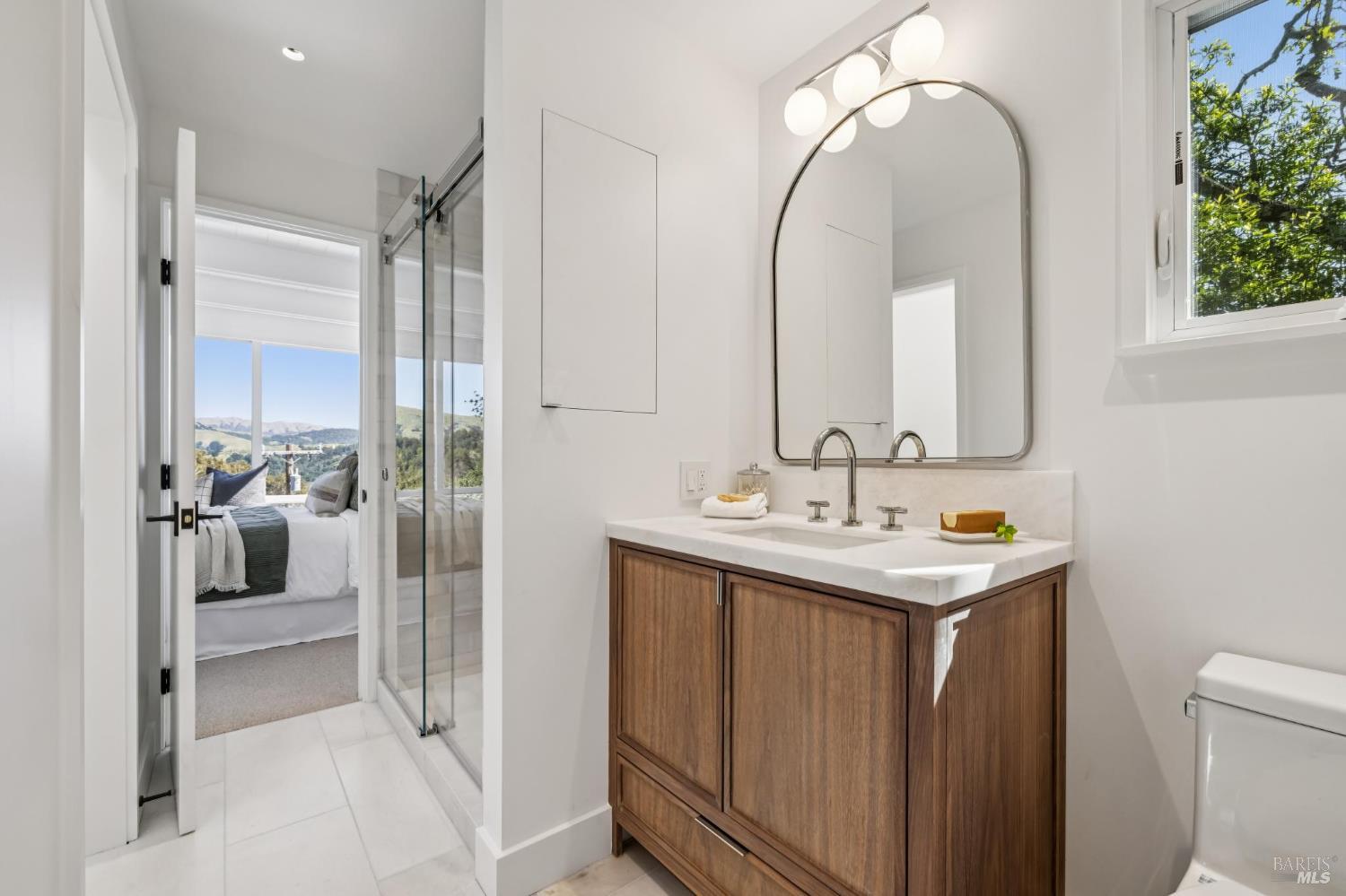 485 Scenic Road Fairfax, CA 94930 - Photo 52 of 75 a bathroom with a sink a toilet and a mirror