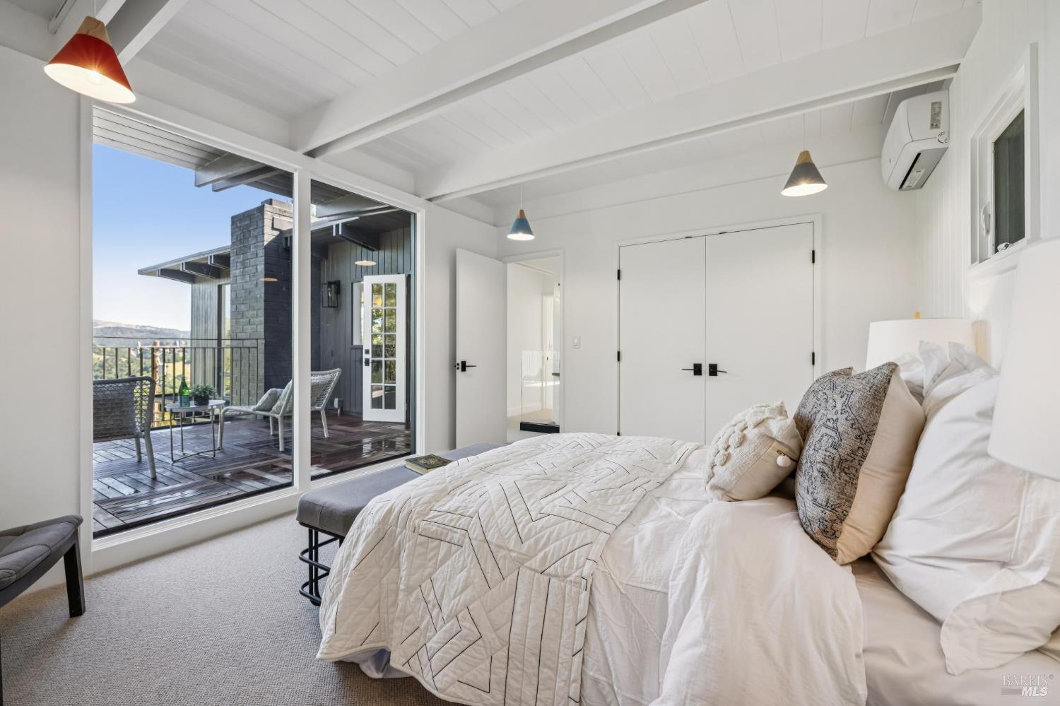 485 Scenic Road Fairfax, CA 94930 - Photo 59 of 75 a bedroom with a bed and a glass door shower