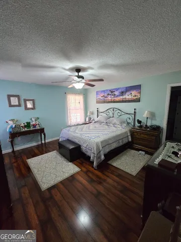 a bedroom with a bed and a dresser in it