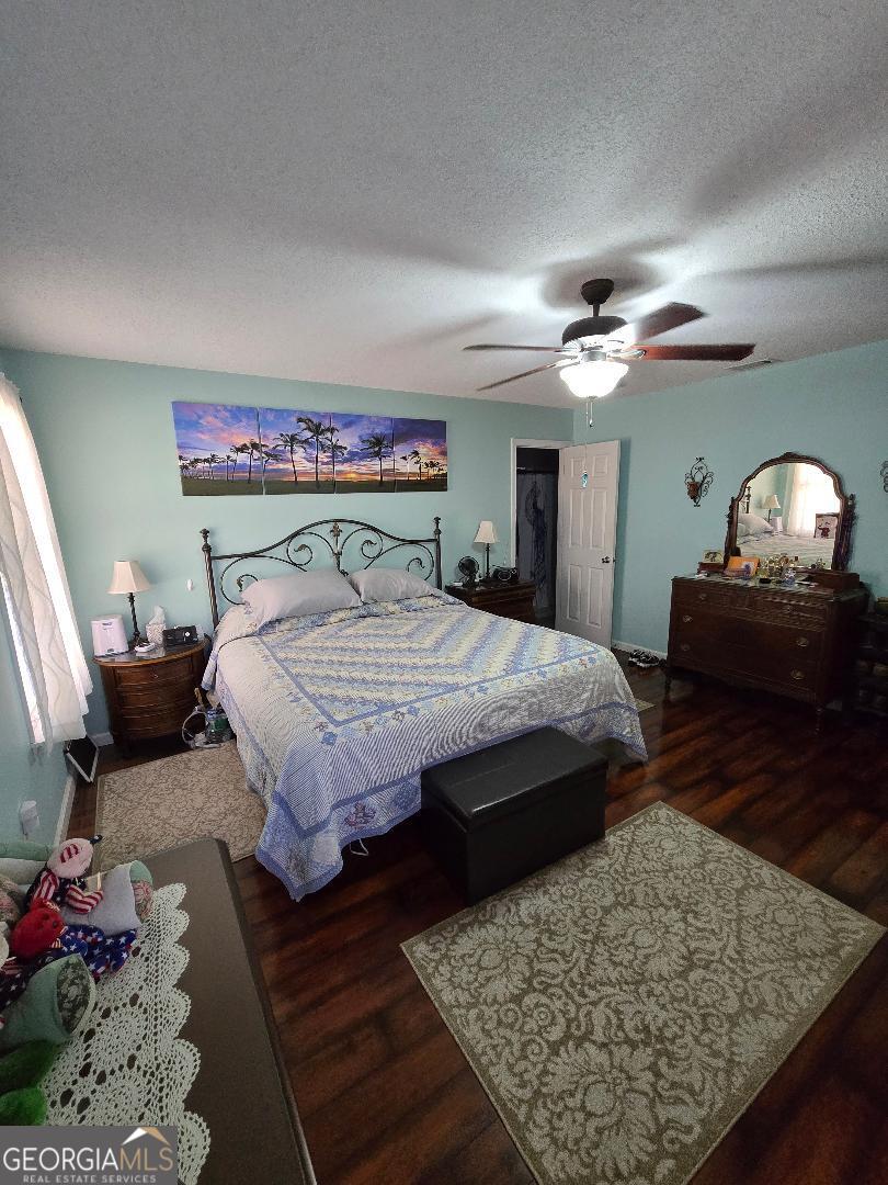 5002 Addison Trail Statesboro, GA 30458 - Photo 14 of 35 a bedroom with a large bed a chandelier and closet