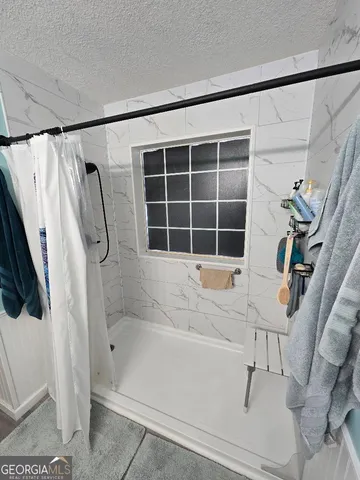 a bathroom with a tub and a window