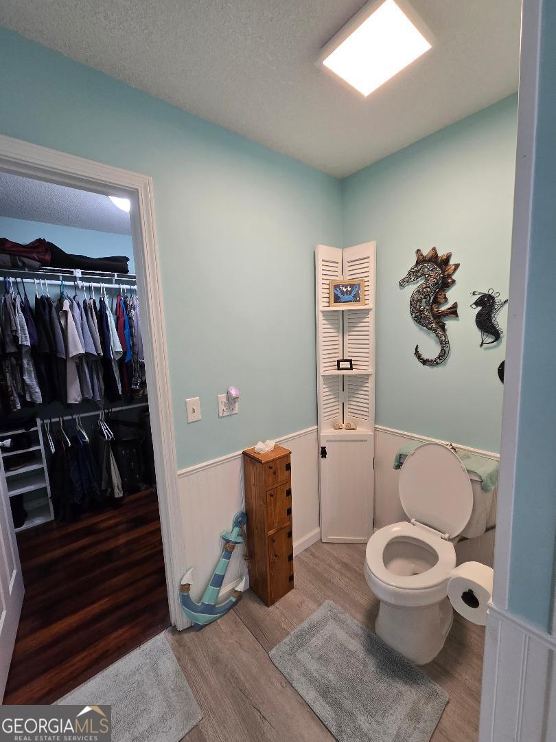 5002 Addison Trail Statesboro, GA 30458 - Photo 19 of 35 a bathroom with a toilet and a book shelf