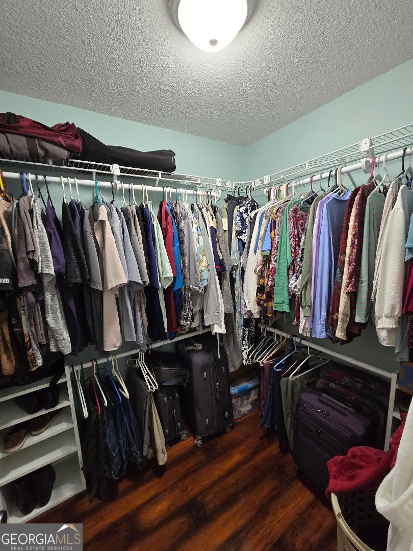 5002 Addison Trail Statesboro, GA 30458 - Photo 20 of 35 a view of walk in closet with clothes and shoes