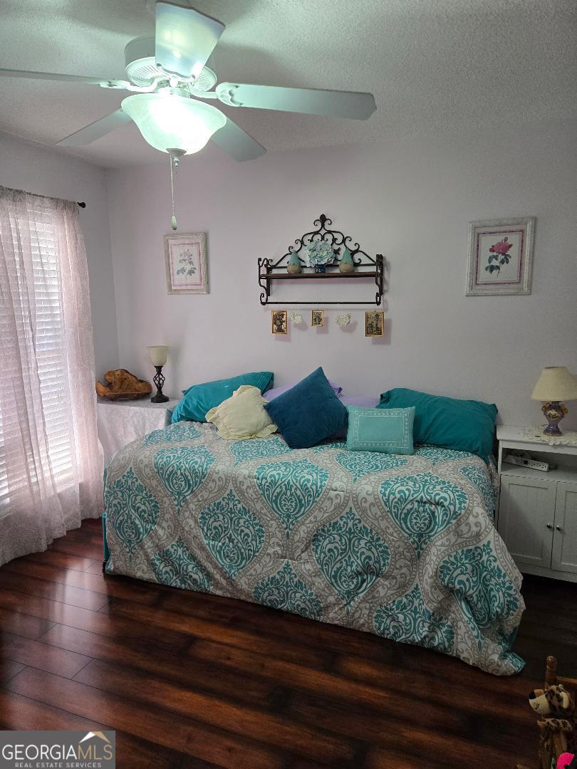 5002 Addison Trail Statesboro, GA 30458 - Photo 22 of 35 a bedroom with a bed and a chandelier