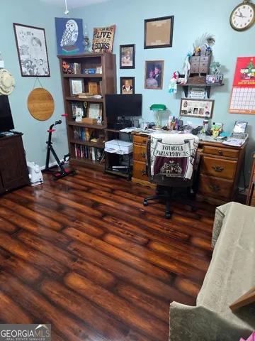 a living room with furniture and painting on the wall