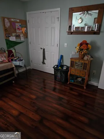 a room with wooden floor and furniture