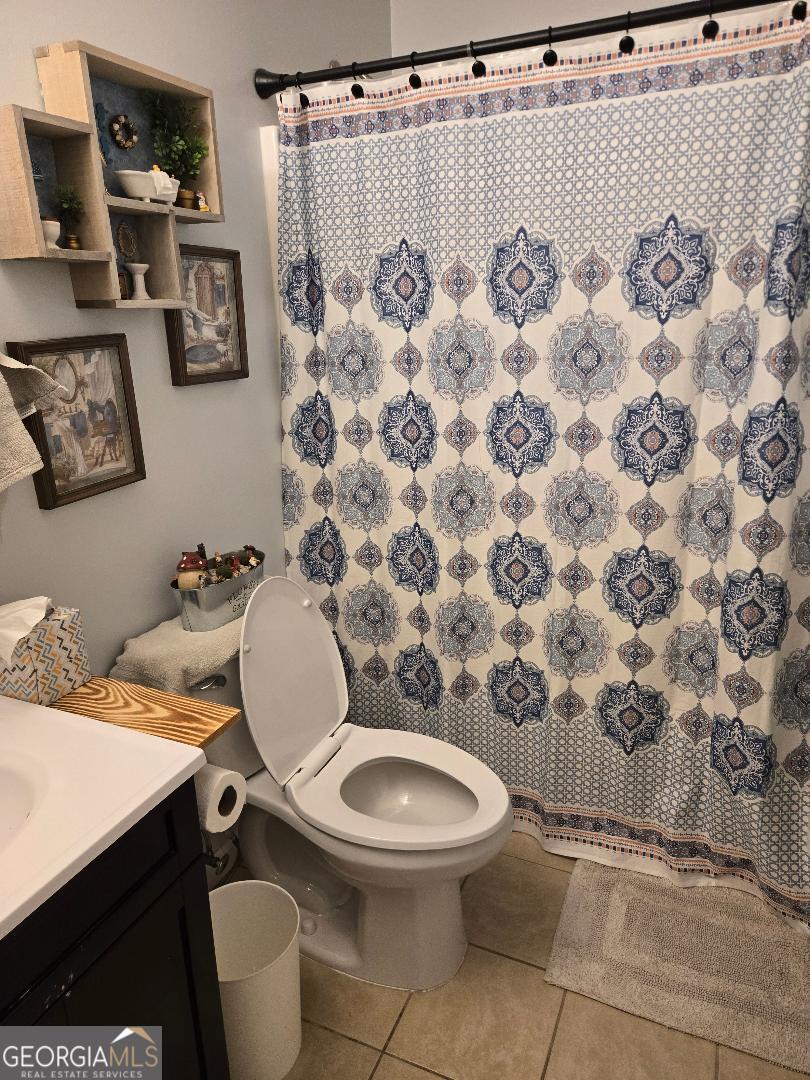 5002 Addison Trail Statesboro, GA 30458 - Photo 27 of 35 a bathroom with a toilet and a shower curtain